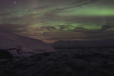 Scenic view of dramatic landscape against sky at night