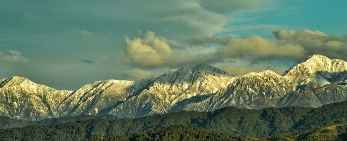 Scenic view of mountains against cloudy sky