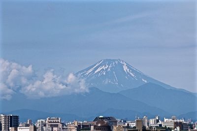 Cityscape with mountain range in background