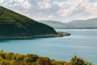 Scenic view of lake and mountains against sky