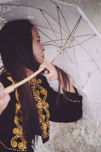 Close-up of woman holding umbrella