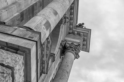 Low angle view of buildings against cloudy sky