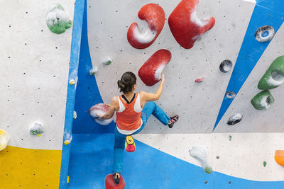 Woman climbing on wall