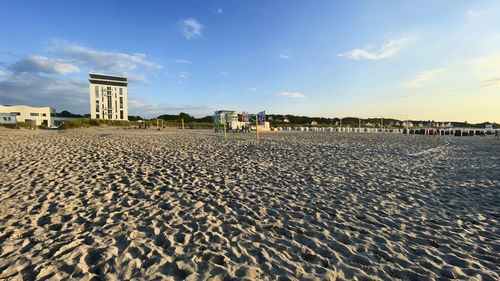 Surface level of beach against sky in city