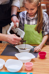 Midsection of man teaching girl