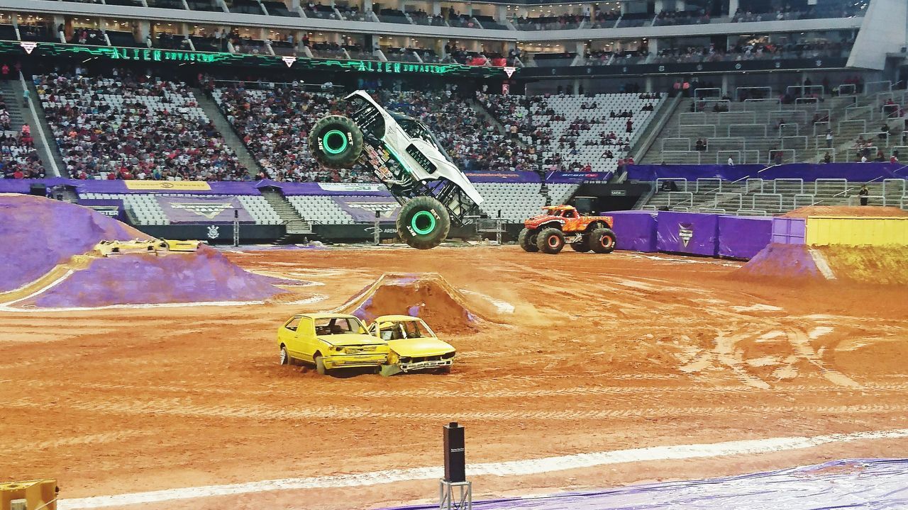 stadium, competition, high angle view, land vehicle, day, sport, sports track, real people, architecture, competitive sport, outdoors, racecar