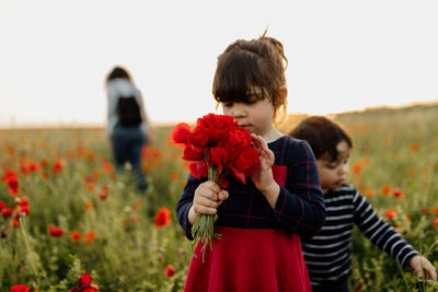 Girl holding bouquet of poppies