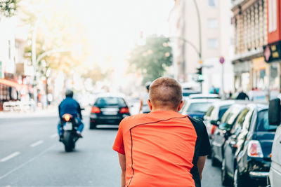 Rear view of man standing on city street