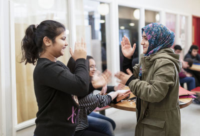 Teenage girls playing in classroom