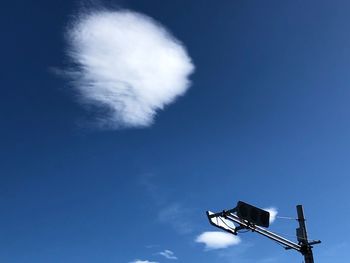 Low angle view of street light against blue sky