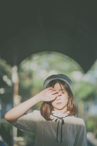 Close-up of young woman with eyes closed standing outdoors