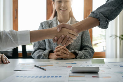 Midsection of business colleagues working at table