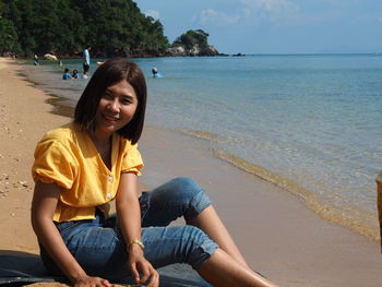 Young woman sitting on beach