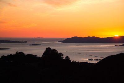 Scenic view of sea against orange sky