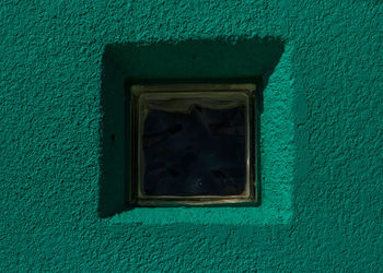 Low angle view of window on wall of house