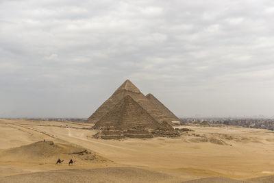 Pyramids against cloudy sky