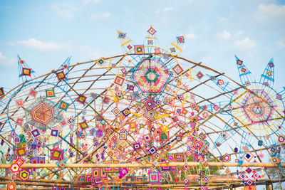 Low angle view of ferris wheel against sky