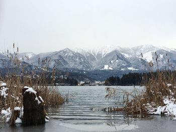 Scenic view of frozen lake against mountains during winter