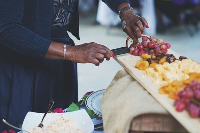 Midsection of man holding fruits