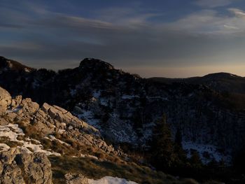 Scenic view of mountains against sky at sunset