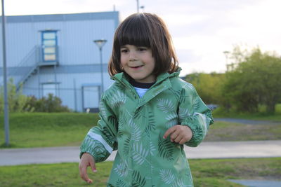 Portrait of smiling boy standing outdoors