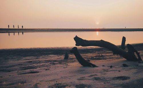 Scenic view of beach against sky during sunset