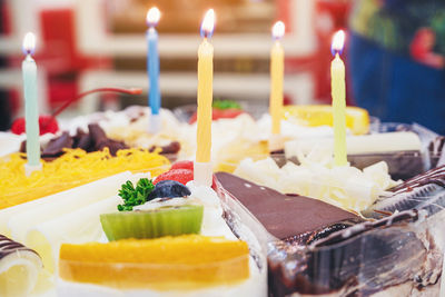 Fresh milk cakes and beautifully decorated fruits with birthday candles prepared to surprise.