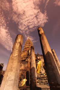 Low angle view of temple against cloudy sky