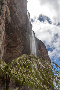 Low angle view of waterfall against sky