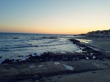 Scenic view of sea against clear sky during sunset