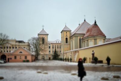 Buildings in city against sky during winter