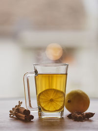 Cup of lemon hot tea honey and cinnamon stick with dried star anise 