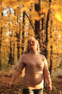 Full length of man standing in forest during autumn