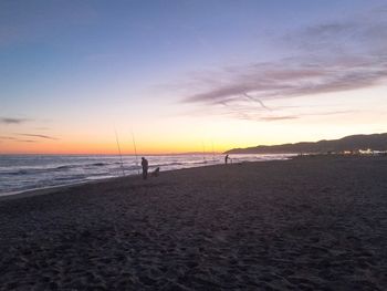 Scenic view of beach against sky during sunset