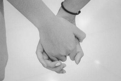 Close-up of hands over white background