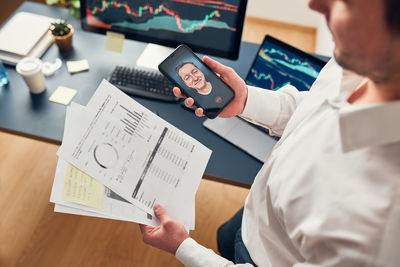 Midsection of businessman working on table