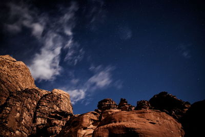 Low angle view of rocks against sky at night