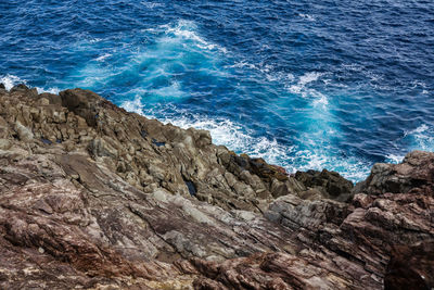 High angle view of rocks in sea