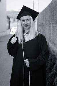 Portrait of woman wearing graduation gown