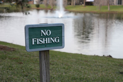 Warning sign at edge of lake