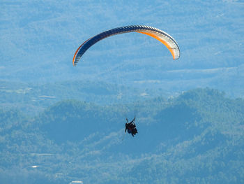 Person paragliding against the sky