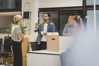 Young businessman discussing with colleagues in new office