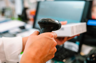 Cropped hand of man holding telephone