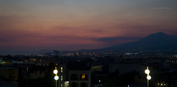 Illuminated cityscape against sky at night