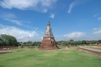 View of temple on building against cloudy sky