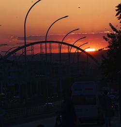 Silhouette city against sky during sunset