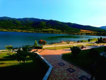 Scenic view of lake and mountains against clear sky