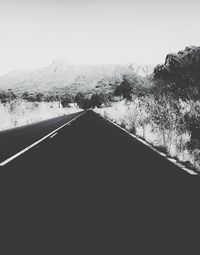 Road by mountain against clear sky