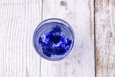 High angle view of blue glass on table