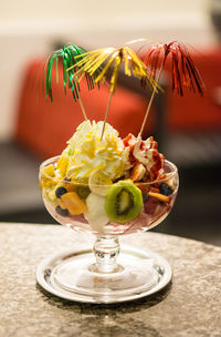 High angle view of ice cream with fruits in bowl on table